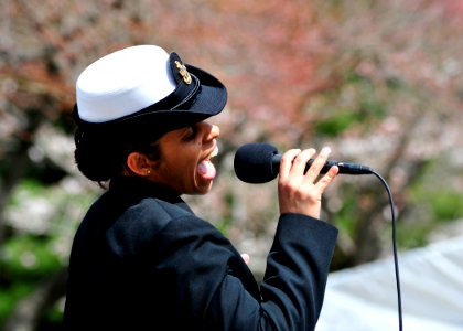 US Navy 110406-N-RO948-041 Chief Musician Lucliada Barbosa sings as the U.S. 7th Fleet Band performs at a city park while on tour in the Republic o