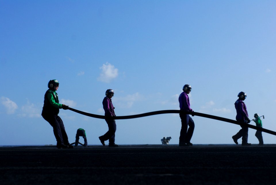 US Navy 110407-N-SB672-017 Sailors place a rubber weather strip on a catapult following flight operations aboard the aircraft carrier USS Ronald Re
