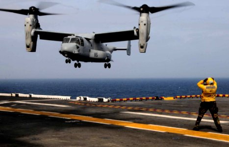 US Navy 110411-N-7508R-004 An aircraft director guides an MV-22B Osprey assigned to Marine Medium Tiltrotor Squadron (VMM) 263 (Reinforced) to a la
