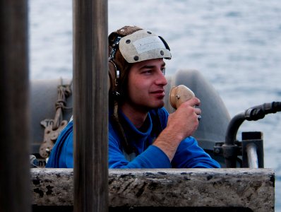 US Navy 110408-N-6505H-201 Aviation Boatswain's Mate (Handling) Airman Christopher Browne talks on a sound-powered telephone to lower Aircraft Elev