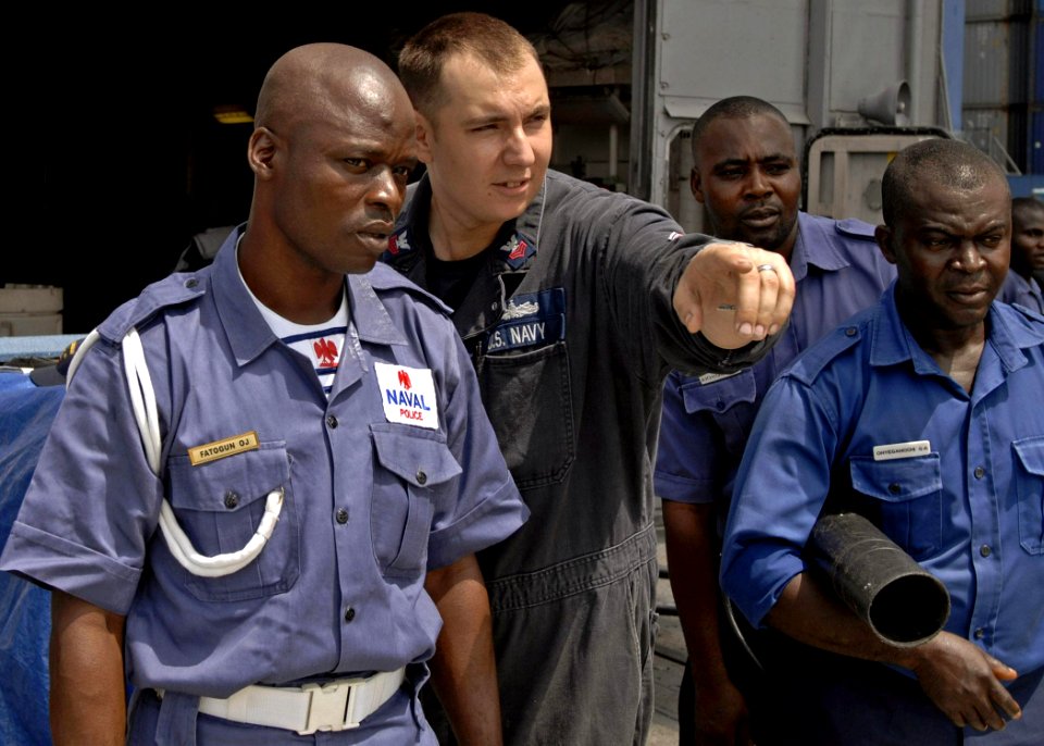 US Navy 110411-N-HI707-410 Hull Technician 1st Class Eric Bell instructs firefighting methods to members of the Nigerian naval police during a dama