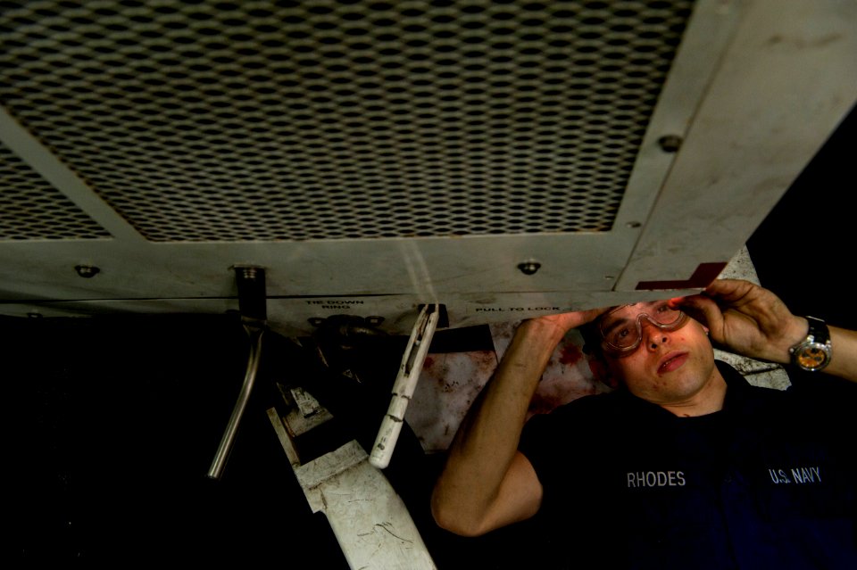 US Navy 110407-N-DR144-544 Aviation Support Equipment Technician Airman Corey Rhodes performs maintenance on a hydraulic generator in the hangar ba