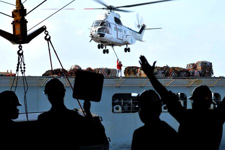 US Navy 110409-N-1004S-005 A civilian crew member assigned to the Military Sealift Command Lewis and Clark-class dry cargo and ammunition ship USNS