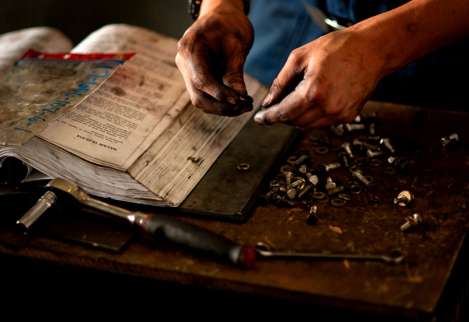 US Navy 110407-N-DR144-257 Aviation Support Equipment Technician 3rd Class Peter Zavala gathers screws to secure panels after adjusting the fuel in