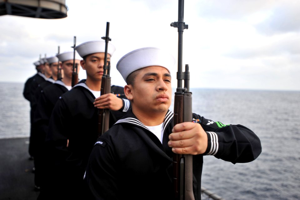 US Navy 110409-N-0569K-167 Sailors render honors during a burial at sea aboard USS Enterprise (CVN 65)