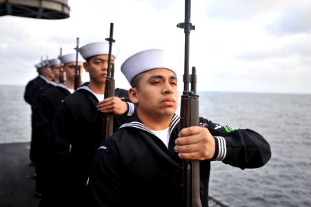 US Navy 110409-N-0569K-167 Sailors render honors during a burial at sea aboard USS Enterprise (CVN 65)
