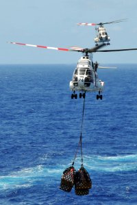 US Navy 110409-N-1004S-632 Two SA-330 Puma helicopter deliver pallets from the Military Sealift Command Lewis and Clark-class dry cargo and ammunit