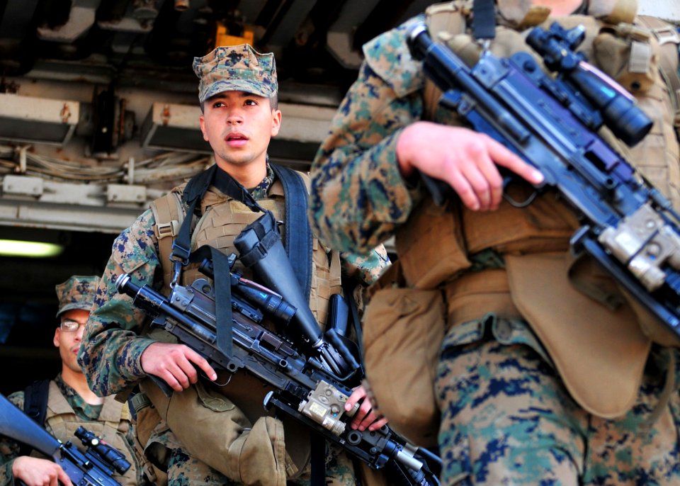 US Navy 110412-N-5538K-417 Marines assigned to the 31st Marine Expeditionary Unit (31st MEU) debark the forward-deployed amphibious assault ship US