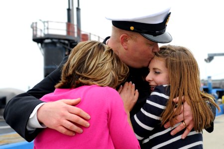 US Navy 110408-N-8467N-006 Senior Chief Sonar Technician (Submarine) Matthew Lindsey hugs his wife and daughter after returning from deployment