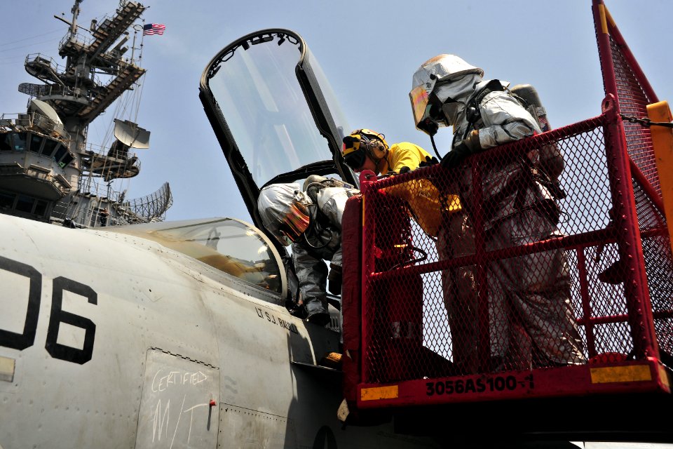 US Navy 110410-N-0074G-143 Sailors simulate rescuing a pilot from the cockpit of an aircraft after an emergency landing aboard USS Enterprise (CVN