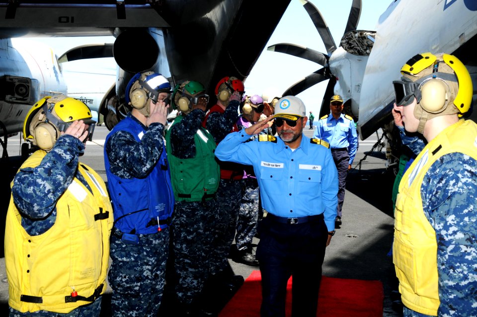 US Navy 110408-N-IC111-016 Indian navy Rear Adm. Harish Bisht, flag officer of Commanding Eastern Fleet, returns honors as he walks through rainbow