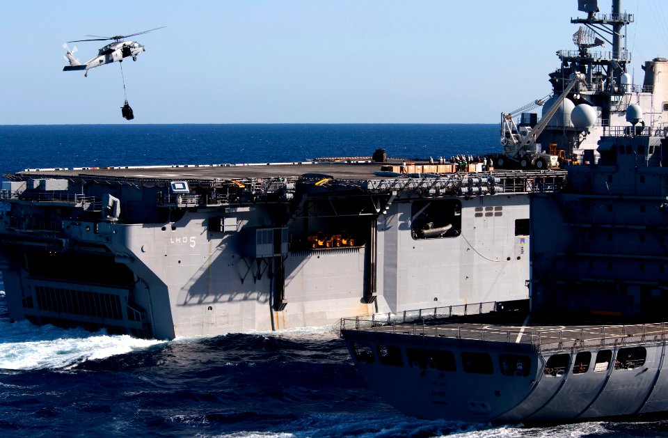 US Navy 110413-N-QP268-173 An MH-60S Sea Hawk helicopter delivers supplies to USS Bataan (LHD 5)