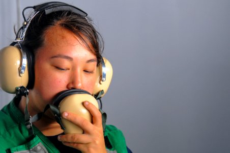 US Navy 110411-N-7488A-090 Seaman Leah Hollingsworth mans a sound-powered telephone while launching a rigid-hull inflatable boat aboard the Nimitz
