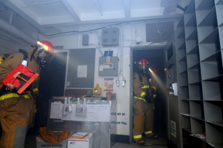 US Navy 110413-N-NB544-028 Sailors assigned to the Ronald Reagan flying squad respond to smoke in the mailroom during an integrated training scenar