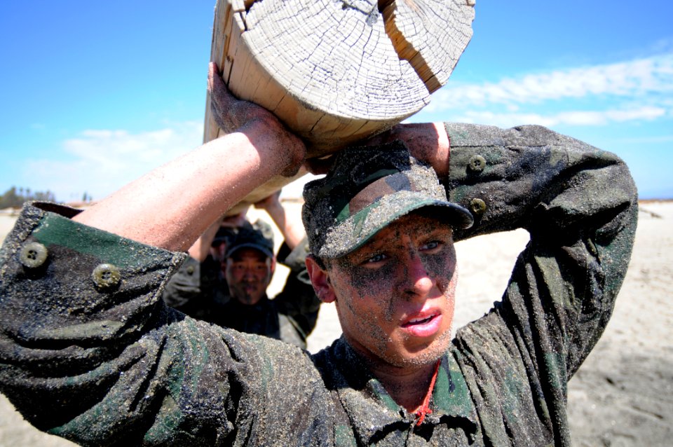 US Navy 110411-N-JR159-138 Students from Basic Underwater Demolition-SEAL (BUD-s) participate in log physical training during the First Phase of tr photo