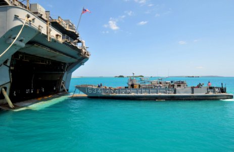 US Navy 110412-N-5538K-492 A landing craft utility approaches the well deck of the forward-deployed amphibious assault ship USS Essex (LHD 2) to of