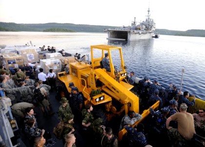 US Navy 110414-N-YM863-039 Personnel and supplies aboard Landing Craft Utility (LCU) 1665 are transported from the amphibious transport dock ship U
