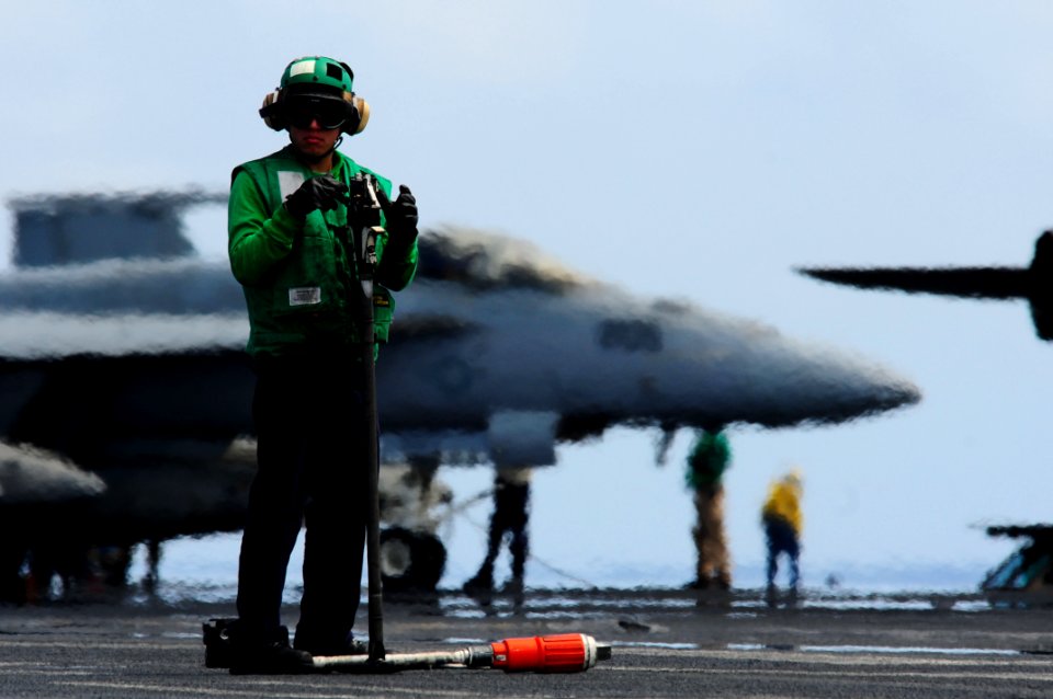 US Navy 110411-N-UO379-162 Aviation Boatswain's Mate (Equipment) Airman Adrian Iglesia, from Los Angeles, performs a safety check on an F-A-18F Sup