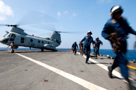 US Navy 110414-N-RC734-134 Flight deck personnel clear the flight deck before a CH-46E Sea Knight helicopter assigned to the Evil Eyes of Marine Me