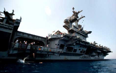 US Navy 110415-N-DR144-833 Sailors jump to the sea from an aircraft elevator during a swim call aboard USS Carl Vinson (CVN 70)