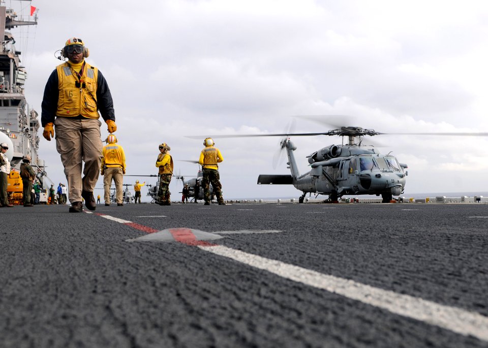 US Navy 110411-N-SO729-217 Sailors and Marines prepare Navy and Marine Corps helicopters for take off from the forward-deployed amphibious assault