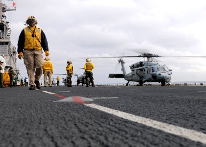 US Navy 110411-N-SO729-217 Sailors and Marines prepare Navy and Marine Corps helicopters for take off from the forward-deployed amphibious assault