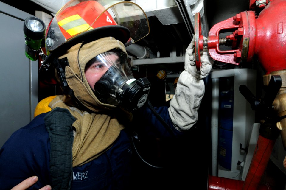 US Navy 110413-N-NB544-077 Damage Controlman Fireman Jeremy Merz, from Indianapolis, charges the plug during an integrated training scenario aboard