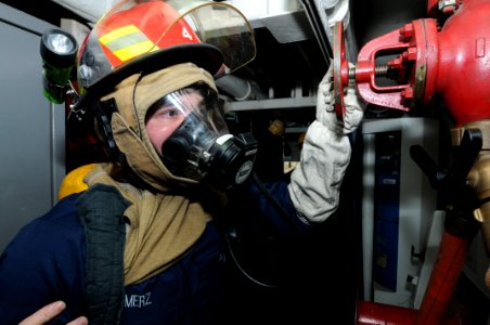 US Navy 110413-N-NB544-077 Damage Controlman Fireman Jeremy Merz, from Indianapolis, charges the plug during an integrated training scenario aboard