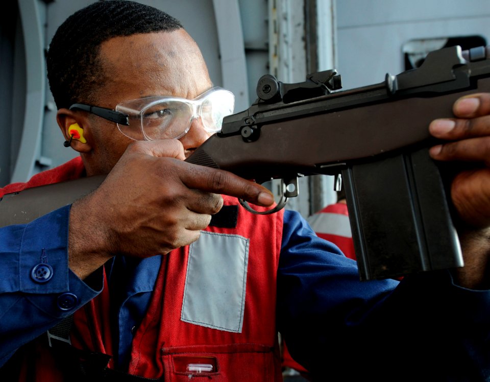 US Navy 110413-N-6320L-206 Gunner's Mate 1st Class Marcus Wrice, assigned to the weapons department's G-2 Division, fires an M14 rifle during a wea