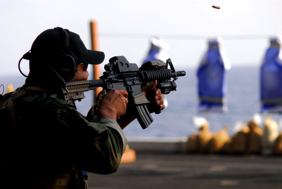 US Navy 110413-N-SB672-546 Explosive Ordnance Disposal Technician 1st Class Rene Varela fires an M-4 carbine during weapons familiarization