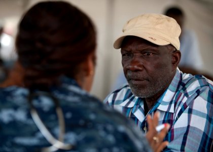 US Navy 110413-N-NY820-211 A Sailor assigned to the Military Sealift Command hospital ship USNS Comfort (T-AH 20) examines a Jamaican man on the fi photo