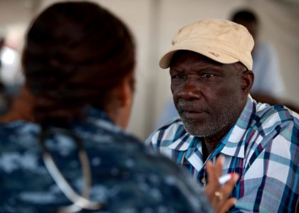 US Navy 110413-N-NY820-211 A Sailor assigned to the Military Sealift Command hospital ship USNS Comfort (T-AH 20) examines a Jamaican man on the fi