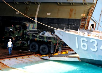 US Navy 110412-N-5538K-569 A 31st Marine Expeditionary Unit (31st MEU) seven-ton truck embarks a landing craft utility from the well deck of the fo photo
