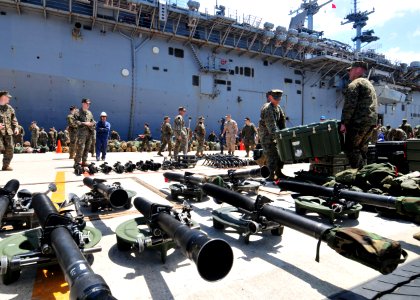 US Navy 110412-N-5538K-380 Marines assigned to the 31st Marine Expeditionary Unit organize equipment after debarking the forward-deployed amphibiou