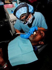 US Navy 110414-N-EP471-245 Brazilian navy Lt. Maria Elisa fills a patient's tooth during a Continuing Promise 2011 medical community service event photo