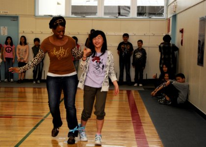 US Navy 110416-N-2653B-097 Yeoman 1st Class Sonya Davis participates in a three-legged race with a Japanese child during a cultural-exchange event photo