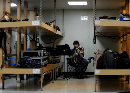 US Navy 110412-N-NY820-147 Musician 3rd Class Loralee Swanson practices the trombone aboard the Military Sealift Command hospital ship USNS Comfort