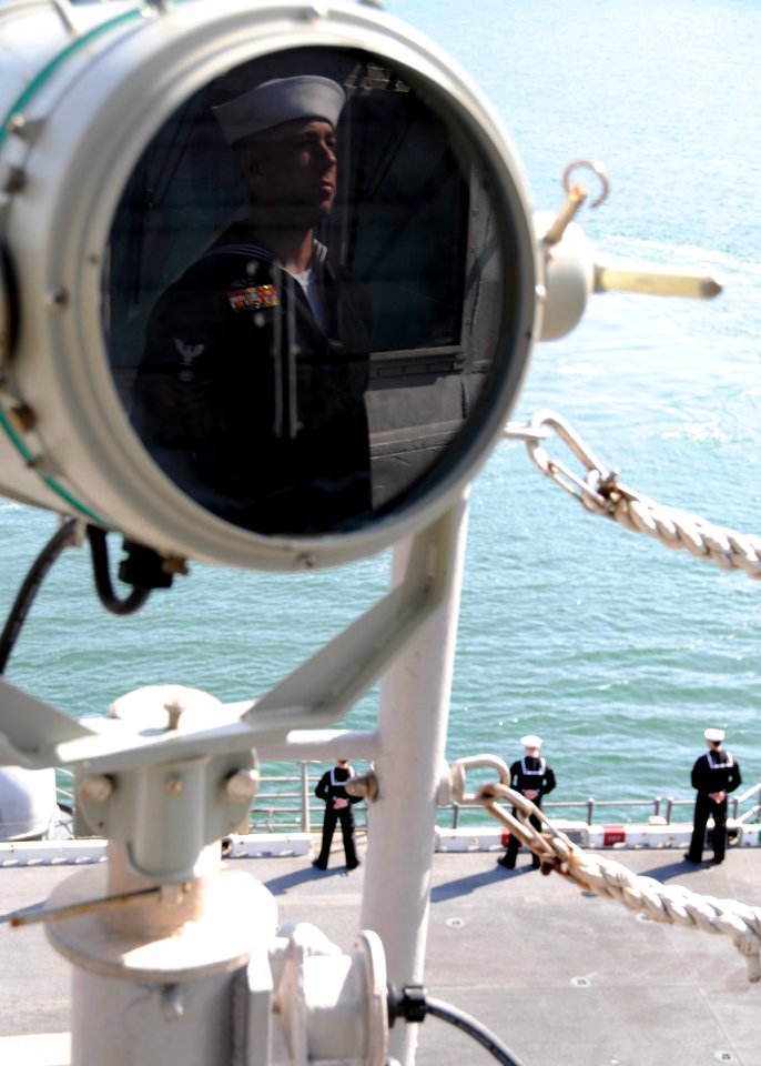 US Navy 110414-N-RU841-019 Quartermaster 1st Class Raymond Steele mans the rails aboard the forward-deployed amphibious assault ship USS Essex (LHD
