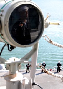 US Navy 110414-N-RU841-019 Quartermaster 1st Class Raymond Steele mans the rails aboard the forward-deployed amphibious assault ship USS Essex (LHD