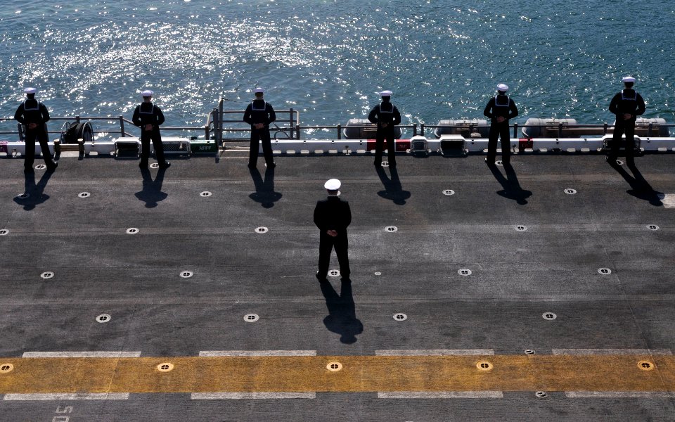 US Navy 110414-N-UA460-044 Sailors man the rails as the amphibious assault ship USS Essex (LHD 2) pulls into Fleet Activities Sasebo