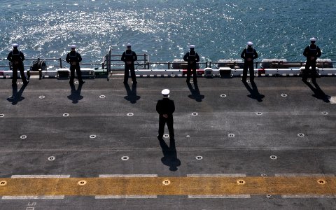 US Navy 110414-N-UA460-044 Sailors man the rails as the amphibious assault ship USS Essex (LHD 2) pulls into Fleet Activities Sasebo
