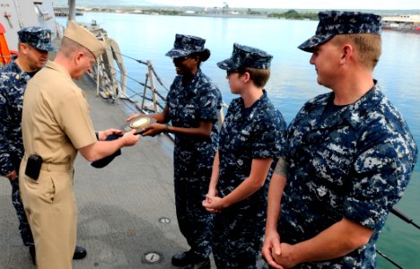 US Navy 110418-N-VM928-041 Master Chief Petty Officer of the Navy (MCPON) Rick D. West is presented with a command ball cap and plaque from Sailors