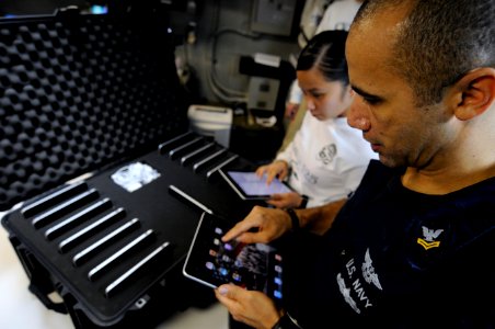 US Navy 110419-N-8040H-111 Information Systems Technician 2nd Class Michael Tolbert, right, and Information Systems Technician 2nd Class An-Marie L