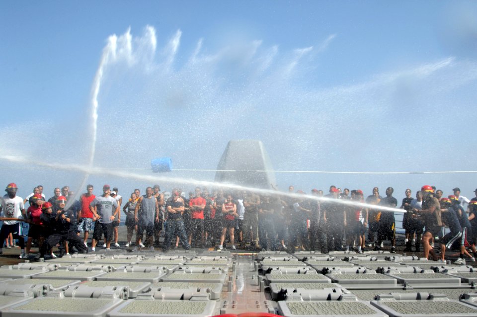 US Navy 110418-N-6006S-084 Sailors aboard the Ticonderoga-class guided-missile cruiser USS Bunker Hill (CG 52) use fire hoses to push a barrel acro