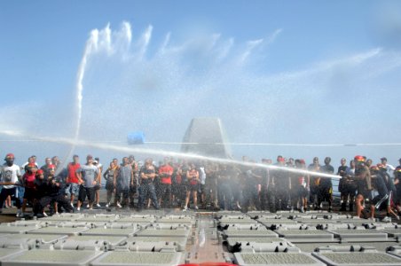 US Navy 110418-N-6006S-084 Sailors aboard the Ticonderoga-class guided-missile cruiser USS Bunker Hill (CG 52) use fire hoses to push a barrel acro