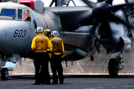 US Navy 110413-N-UO379-026 A qualified aircraft handler advises two Sailors being trained as aircraft handlers before launching an E-2C Hawkeye