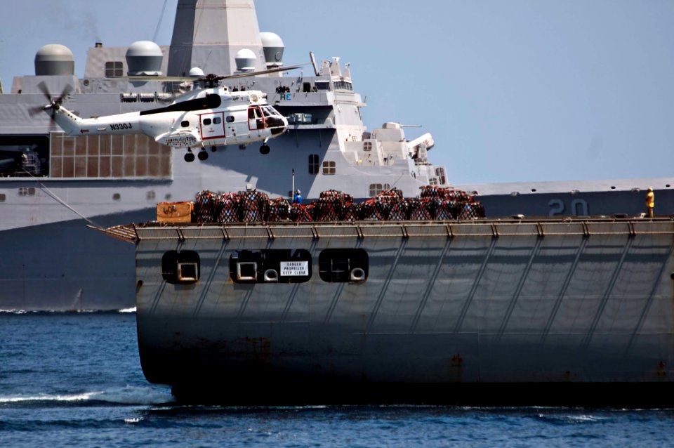 US Navy 110419-N-RC734-504 An AS-332 Super Puma helicopter picks up cargo from the Military Sealift Command dry cargo and ammunition ship USNS Alan