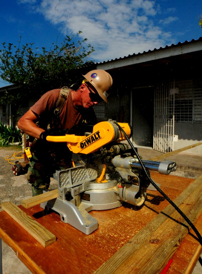 US Navy 110415-N-EP471-134 A Seabee assigned to Naval Mobile Construction Battalion (NMCB) 28 cuts wood for a guard shack