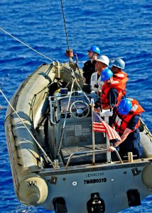 US Navy 110420-N-XO436-060 Sailors assigned to the Arleigh Burke-class guided-missile destroyer USS Barry (DDG 52) are hoisted back onto the ship a