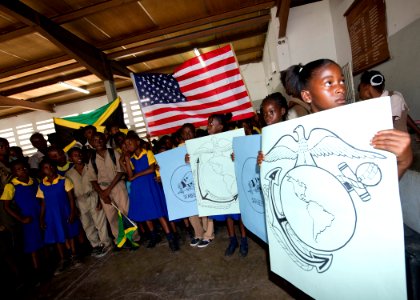 US Navy 110419-N-RM525-632 Students from Trenchtown Primary School showcase drawings of the U.S. Marine Corps and Seabee emblem